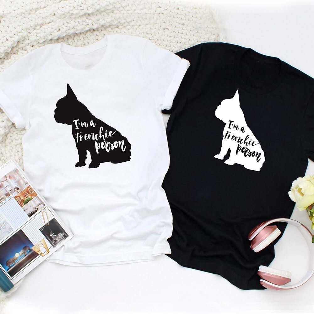 Flat lay shot of two t-shirts with French bulldog prints.