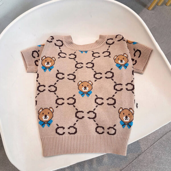 Flat lay shot of the Couture Teddy Bear Frenchie Cardigan on the chair