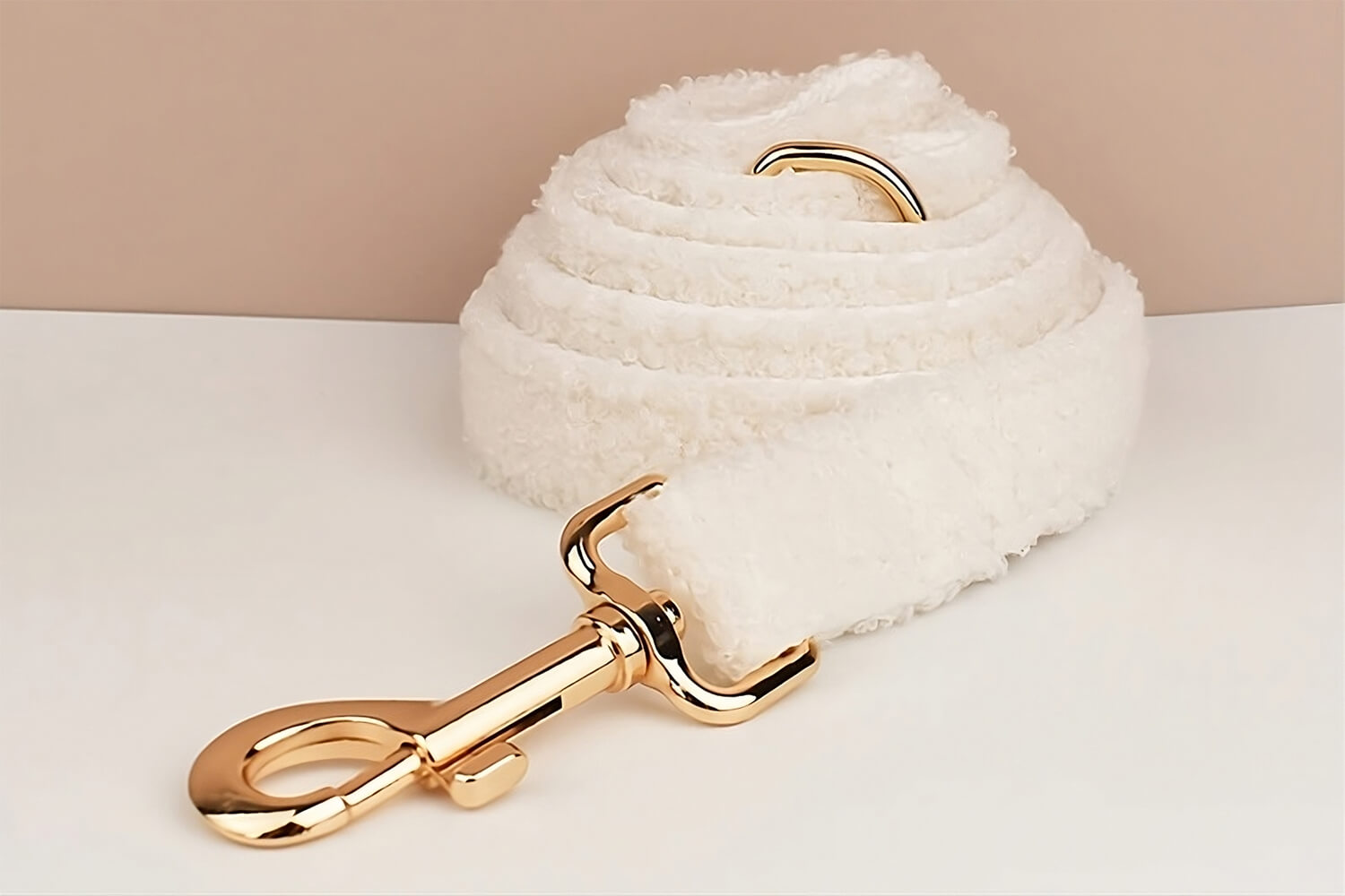 Product shot of the furry dog leash against apricot background
