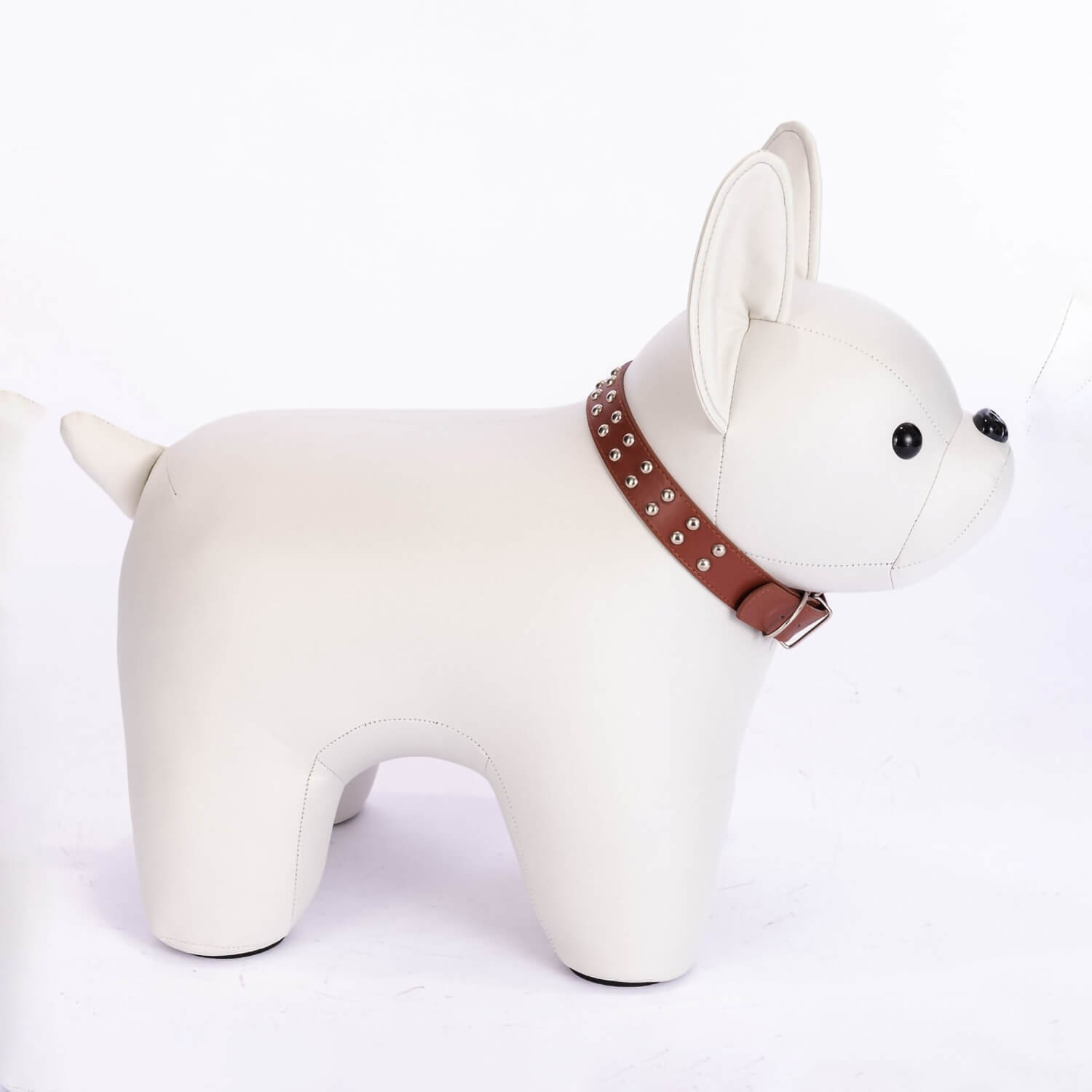 Side shot of off white colored French Bulldog shaped stool