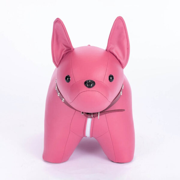 Front shot of pink colored French Bulldog shaped stool, against white background.