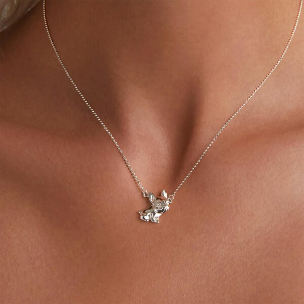 Close up shot of the Silver French Bulldog Charm Necklace around woman's neck