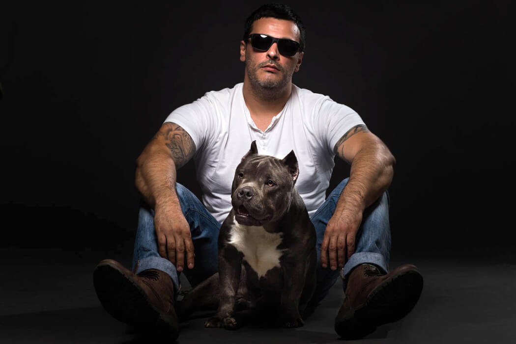 American bully with his owner